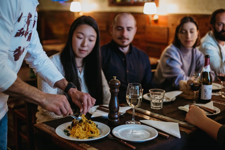 Lisbon: Evening Food & Wine Tour in Bairro Alto - Grapes & Bites and Hostel and Wines: a drink-led change of gear