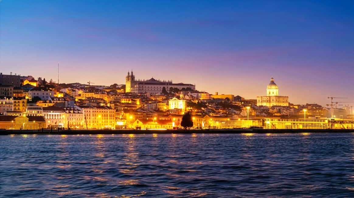 Lisbon Night Cruise: Illuminated Sights on the Tagus River - Christ the King from the river: a silhouette that reads at night
