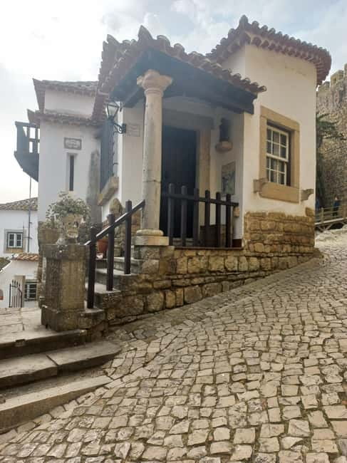 Lisbon: Transfer to Porto with Obidos and Nazare - Nazaré dunes and beach time: surfing energy and smart lunch timing
