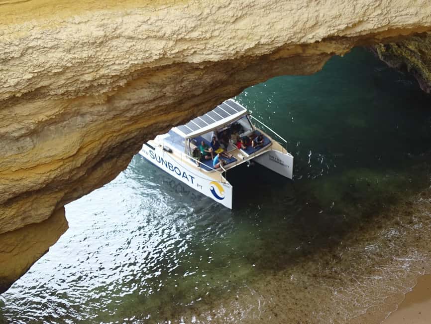 Portimao: SUNSET Benagil Caves Tour | Eco Catamaran - Portimão sunset cruising on an eco catamaran (not a typical speedboat vibe)